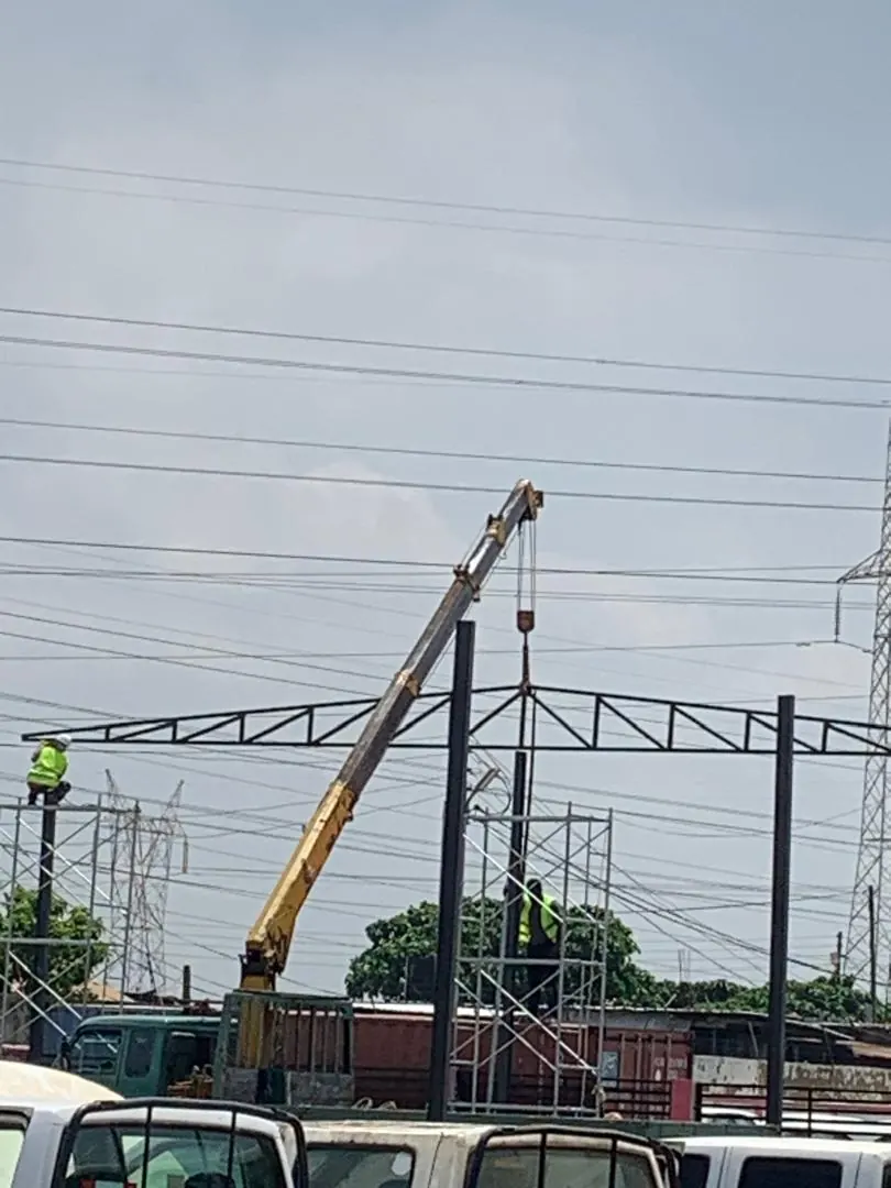 Steel structure being erected by crane on a GIWU project site in Ghana