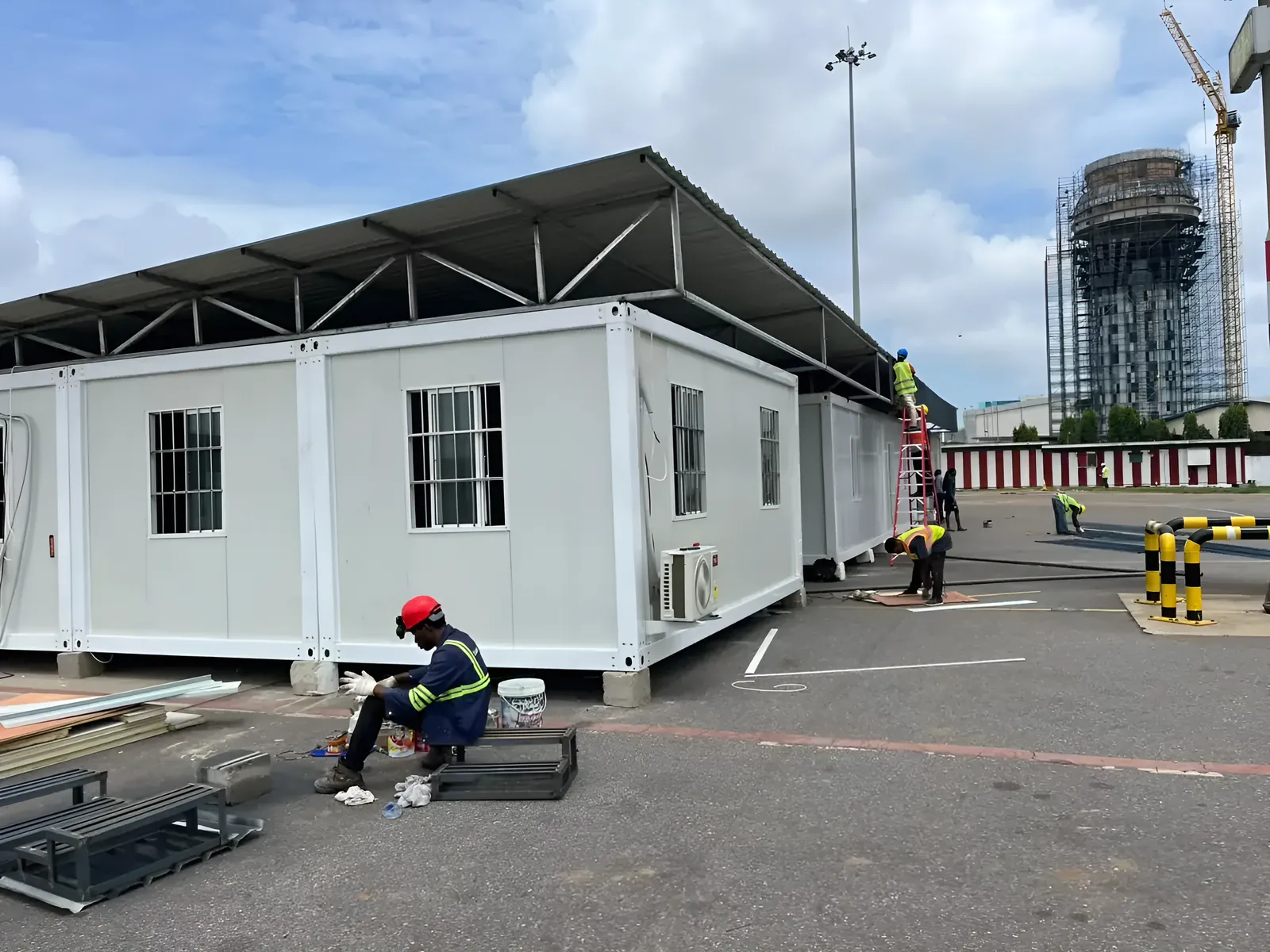 GIWU engineer installing prefabricated offices under a steel canopy at a project site in Ghana